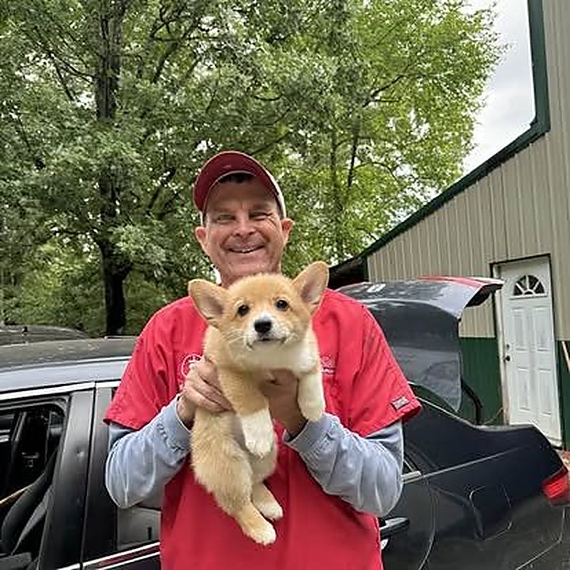 Dr. Tyler Verble holding a corgi puppy